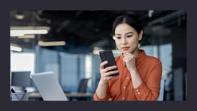 Woman checking phone in office