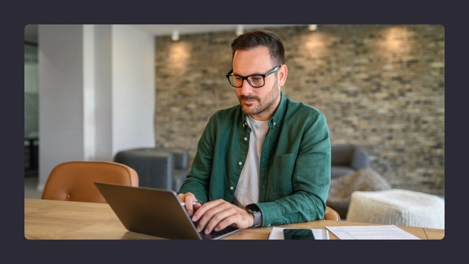 Man working on laptop in modern office