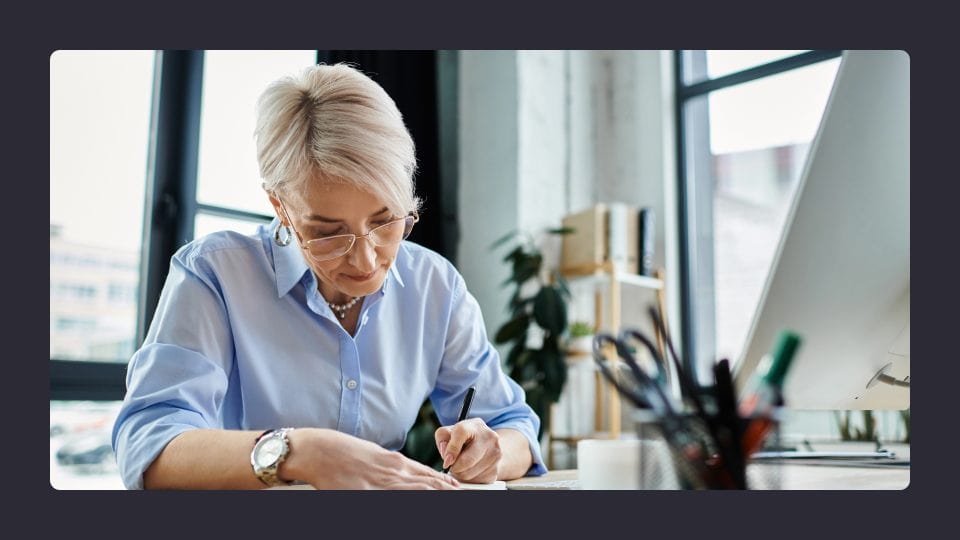 Woman working on laptop in bright office