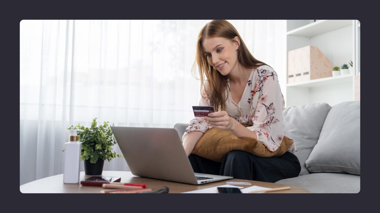 Woman shopping online with credit card at home