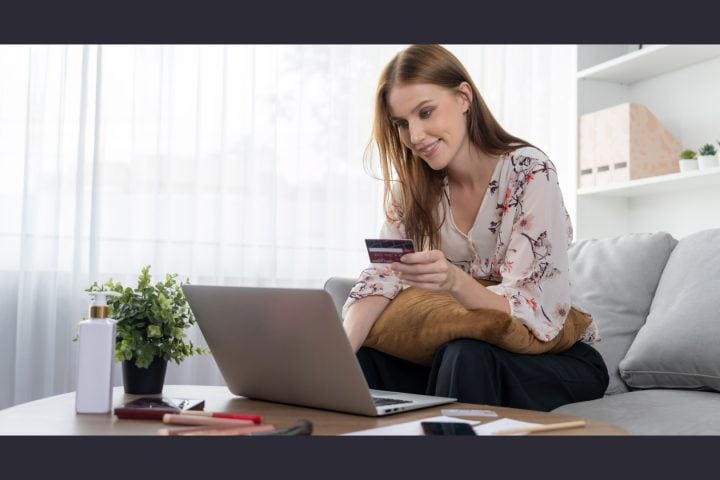 Woman shopping online with credit card at home