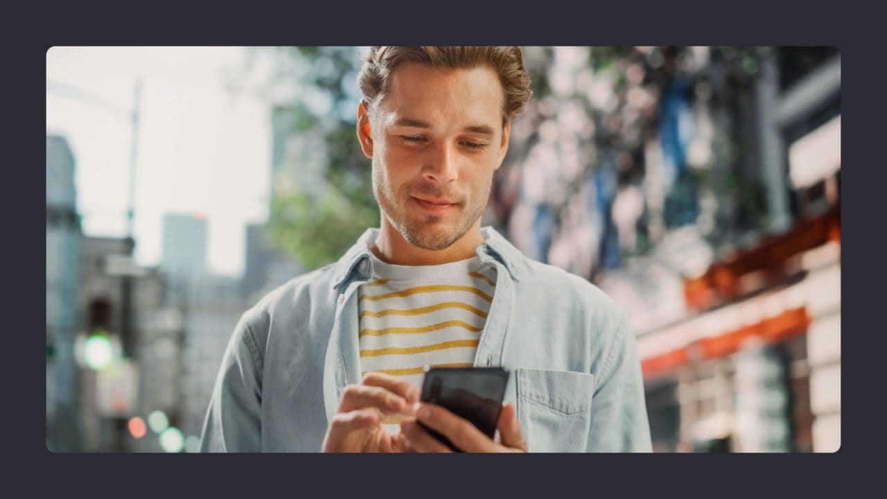 Man texting on smartphone in urban setting