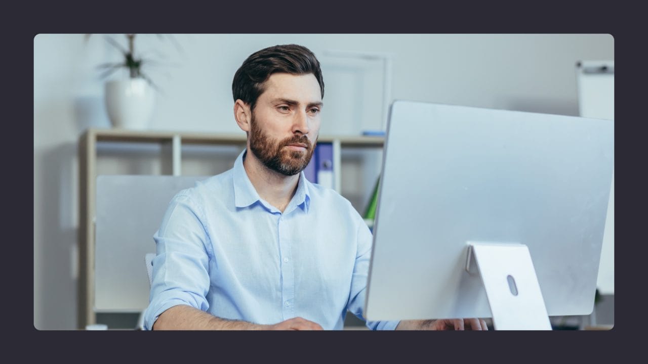 Man working attentively on computer in office