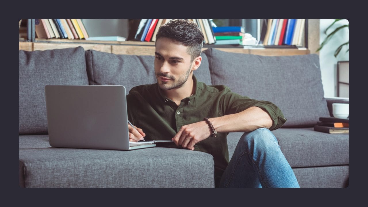 Man working on laptop while sitting on couch