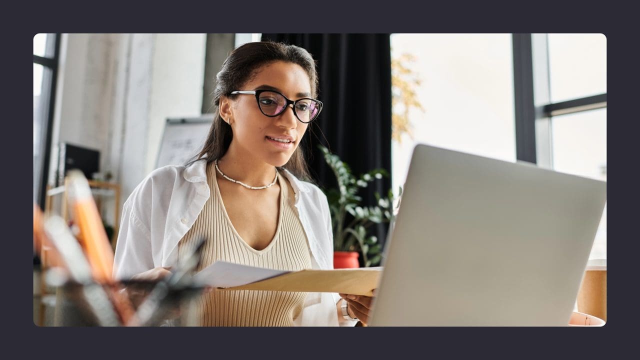 Young woman working intently on laptop in office