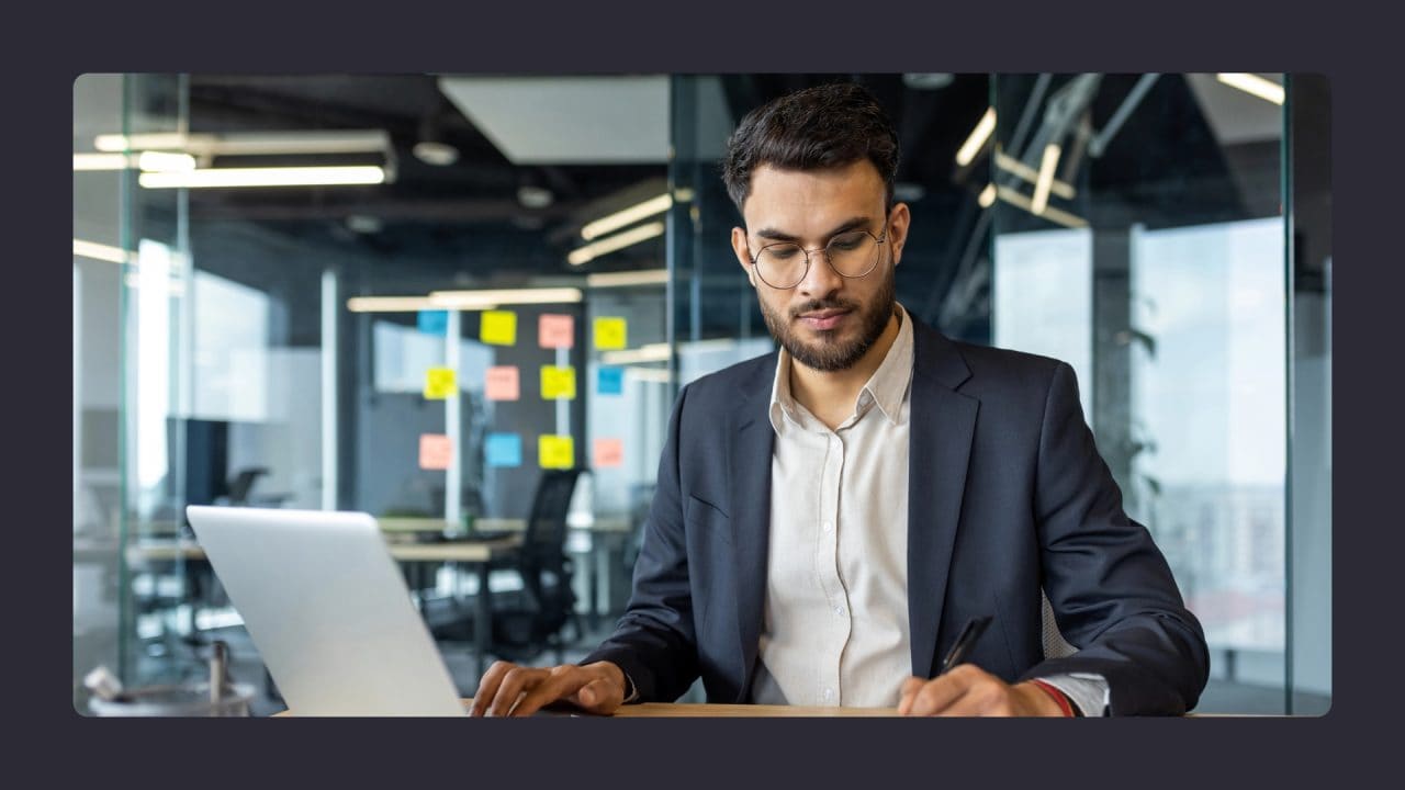 Professional man working on laptop in modern office