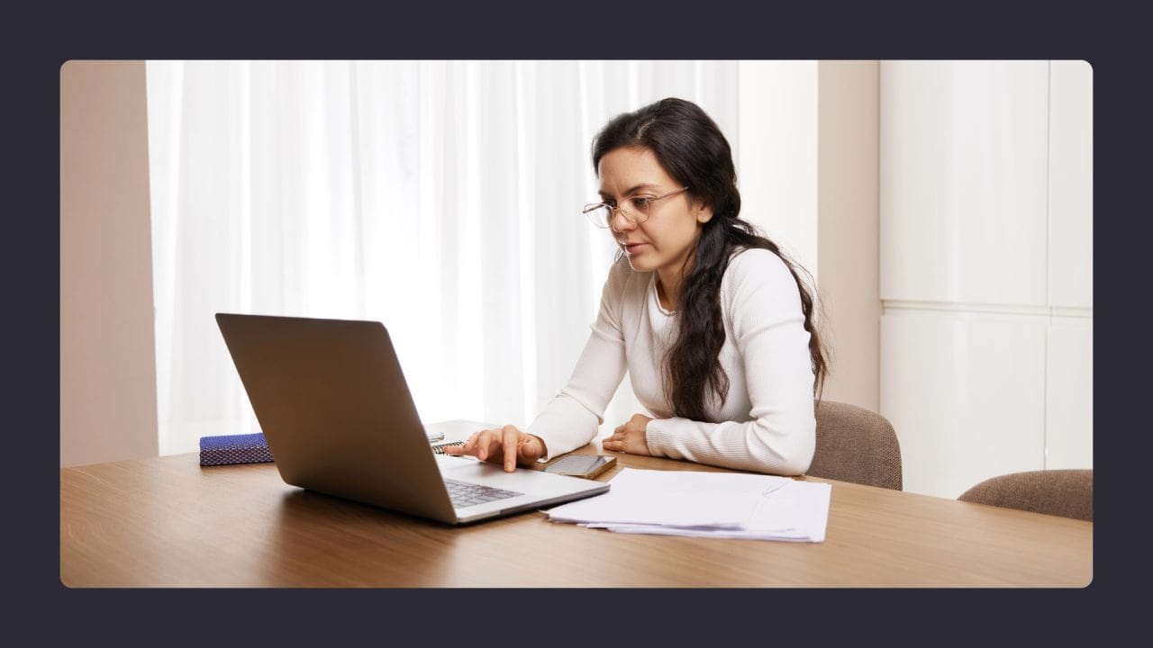 Woman concentrating on laptop in office setting