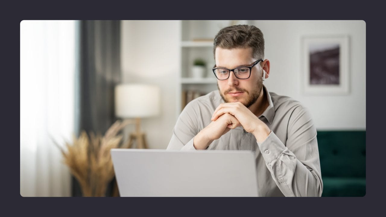 Focused man working on laptop at home