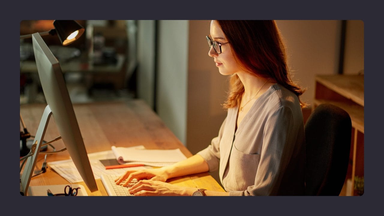 Woman working late in office on computer