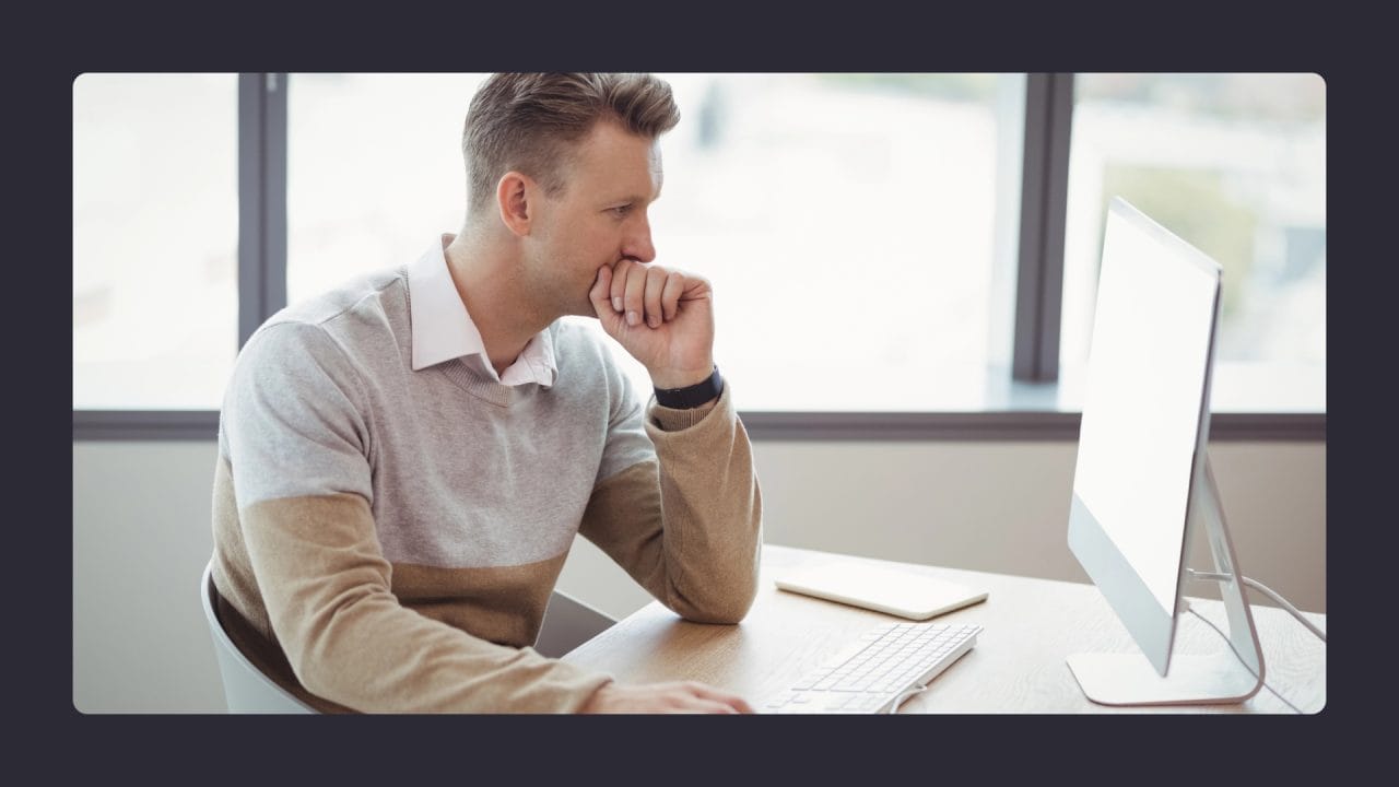 Man intently working on computer in office