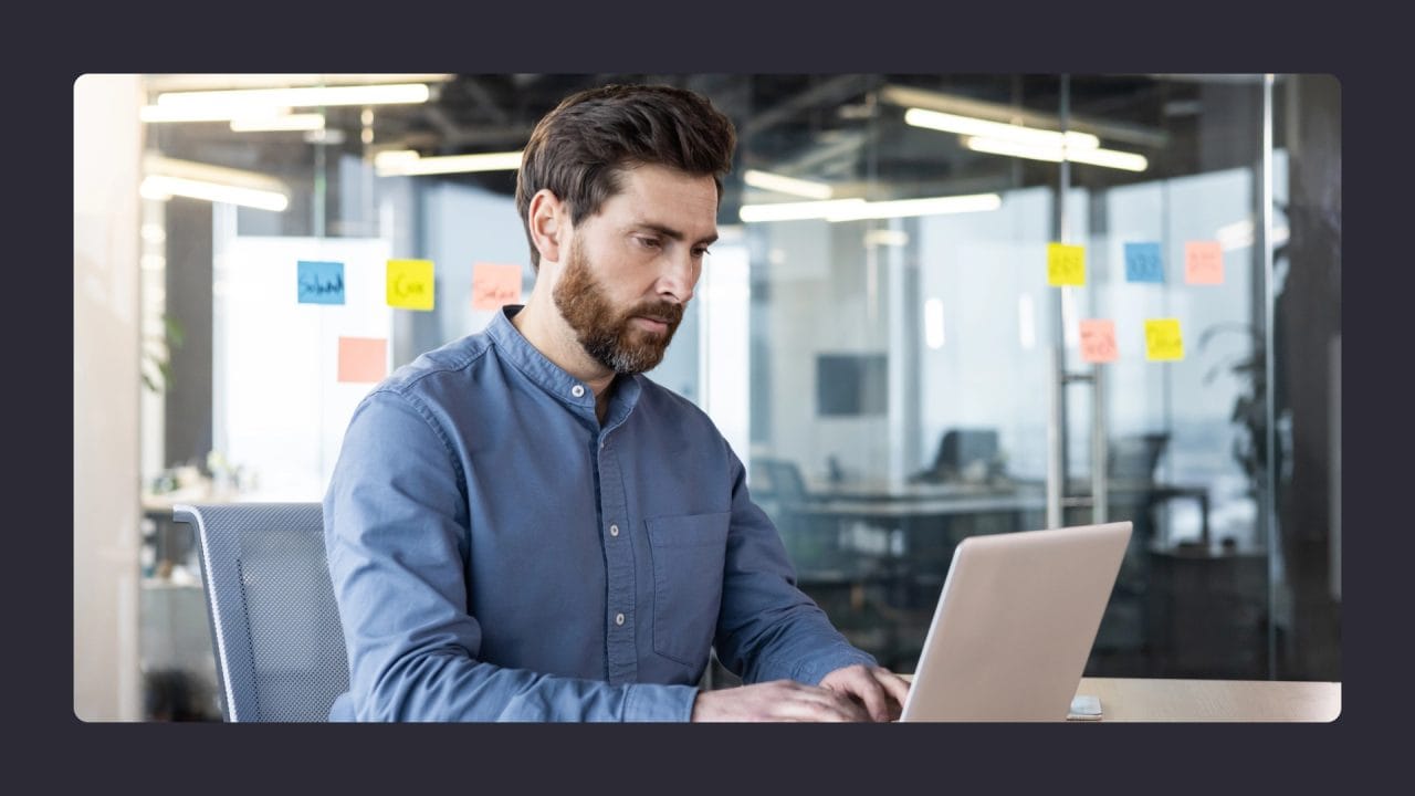 Man working on laptop in modern office