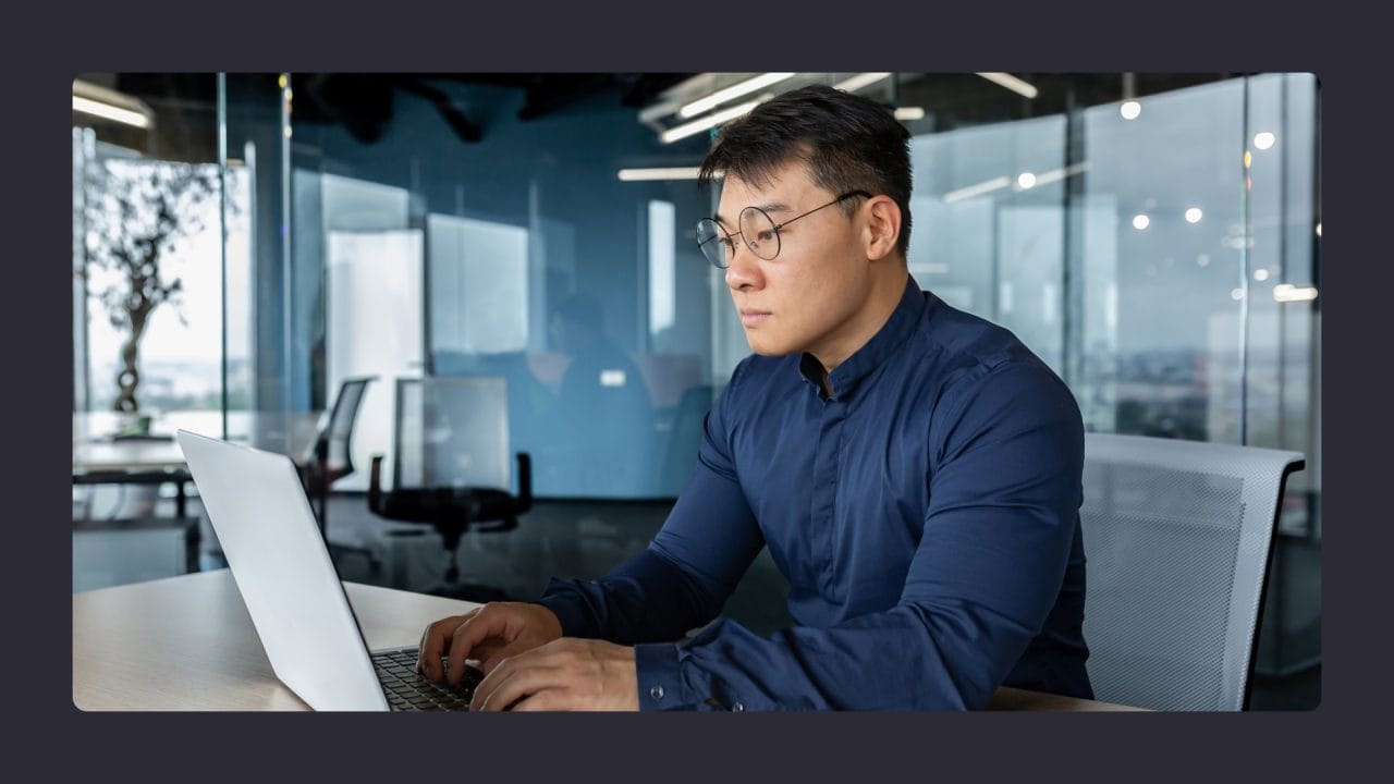 Man working on laptop in modern office